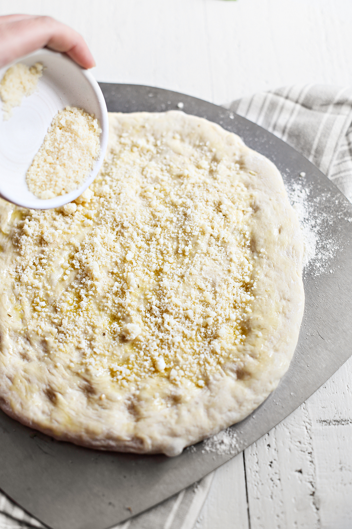 Sprinkling Cheese On Caprese Pizza Good Life Eats