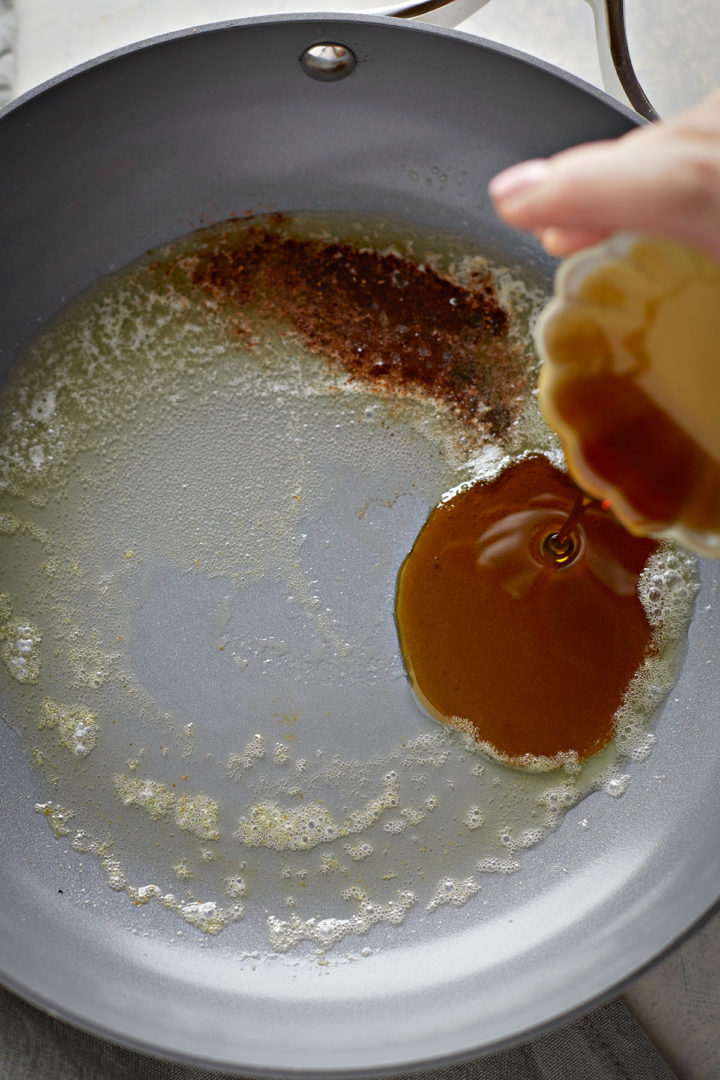 woman adding pear compote ingredients to a pan