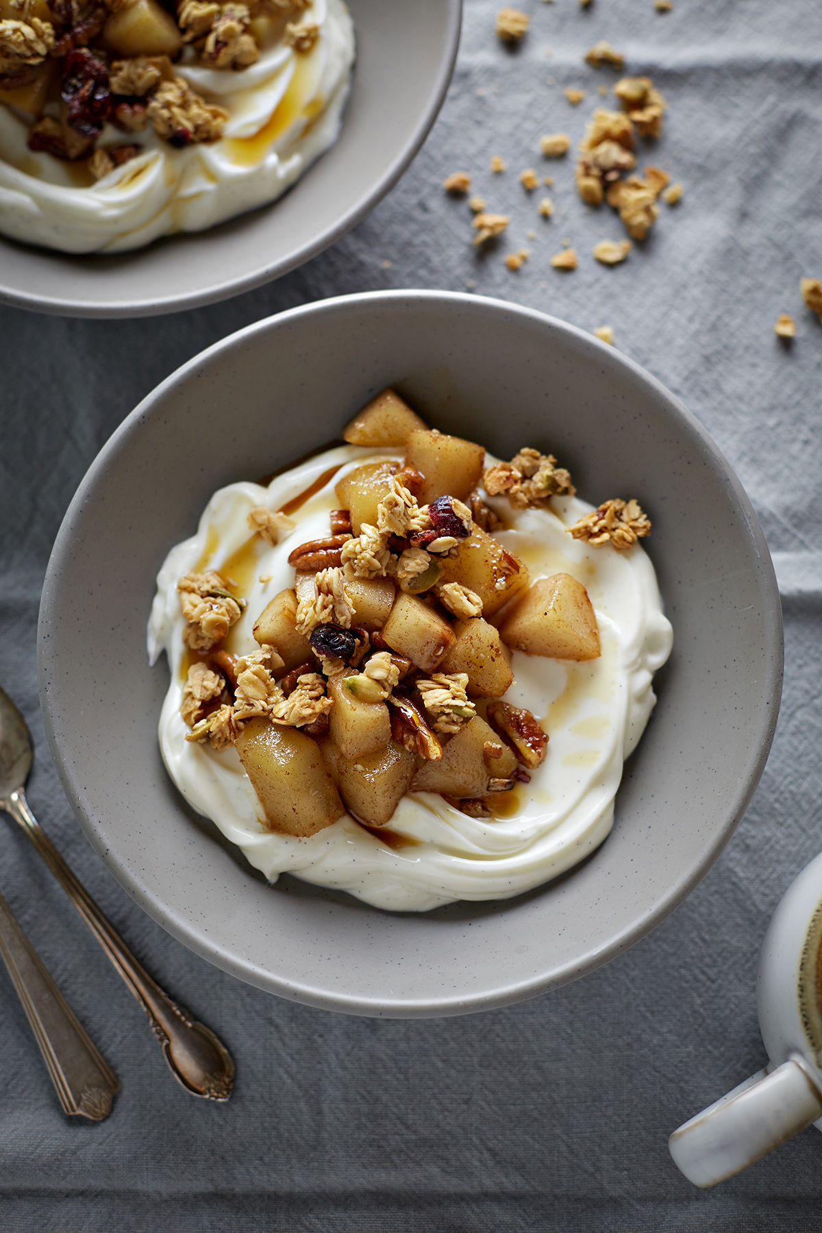 granola with yogurt and pear compote in a bowl