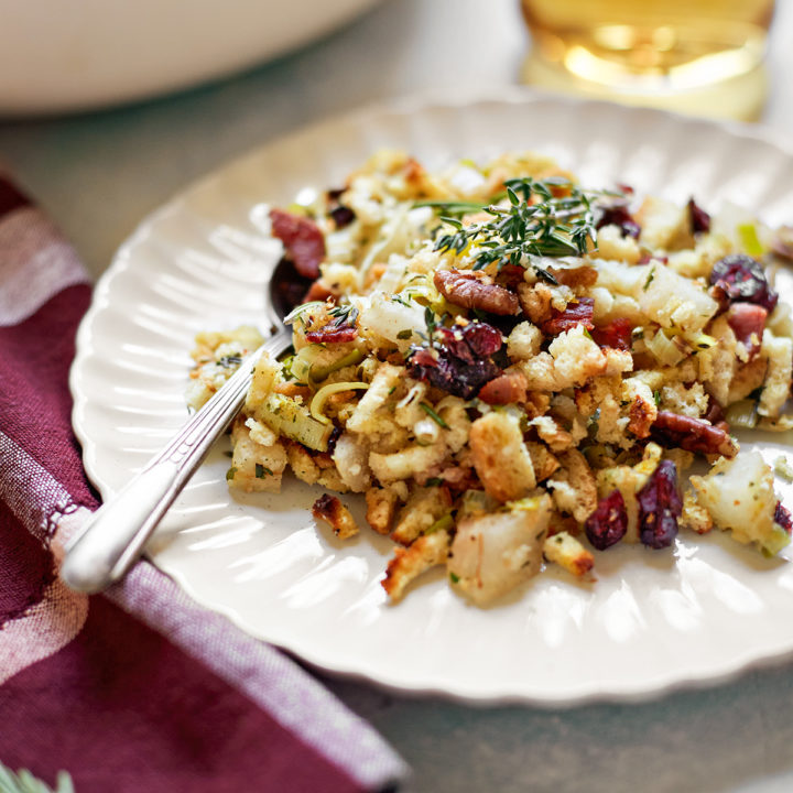 a plate of stuffing with leeks on a thanksgiving table