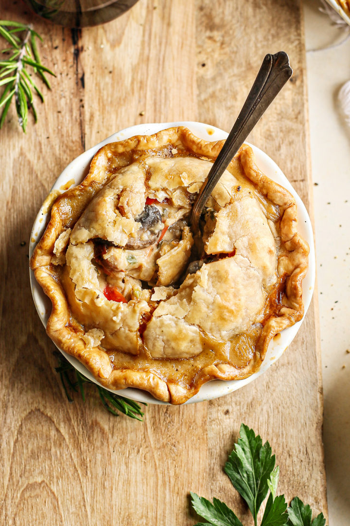 overhead photo of a mini chicken pot pie on a wooden cutting board