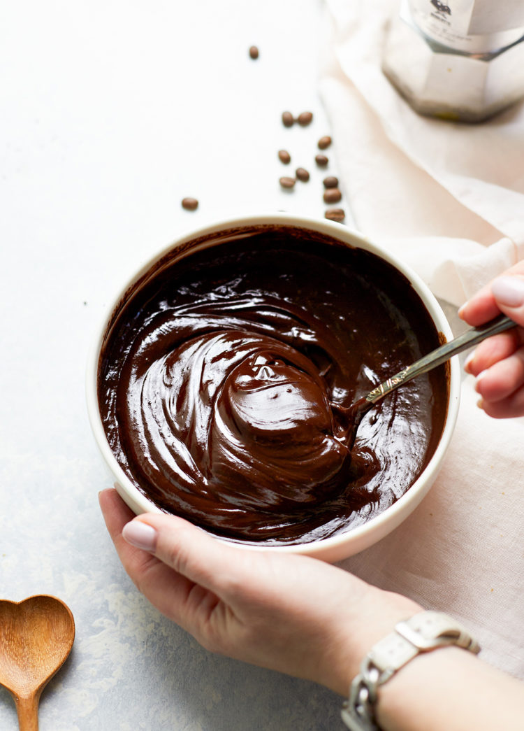 woman stirring a bowl of chocolate ganache