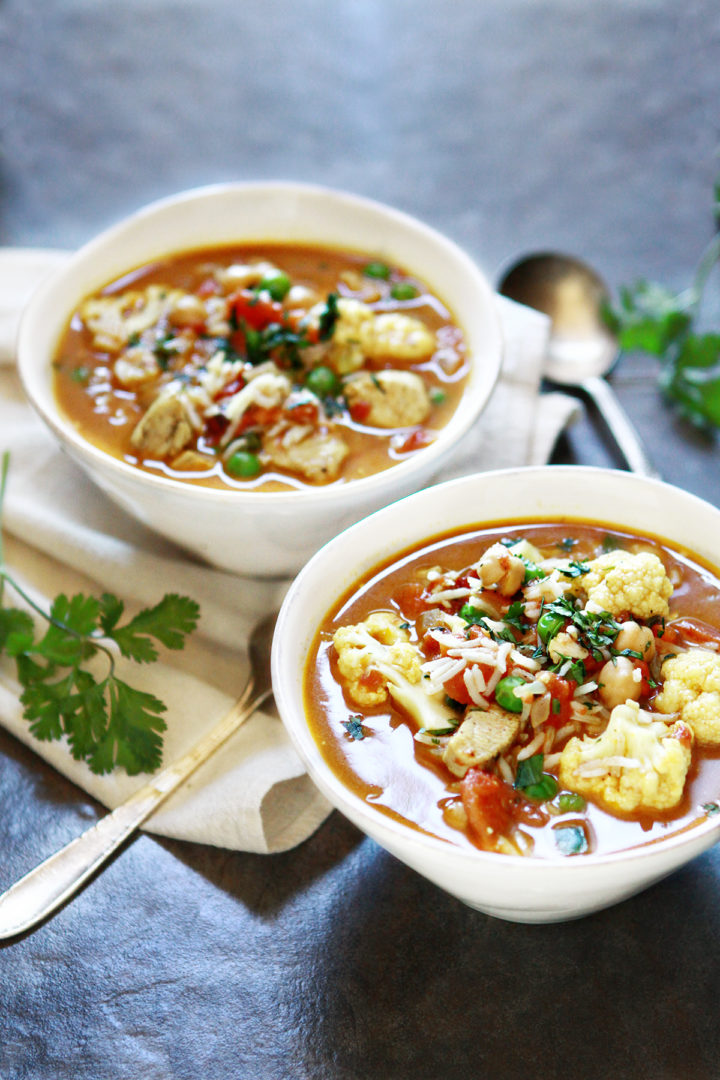 two white bowls of curry chickpea soup