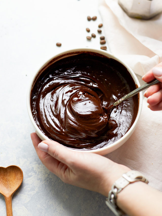 woman stirring a bowl of chocolate ganache