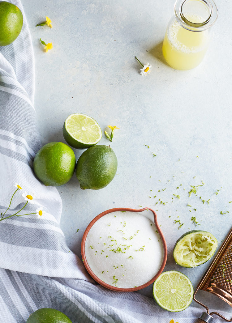 fresh limes, a bottle of fresh squeezed juice from a lime, and freshly squeezed limes