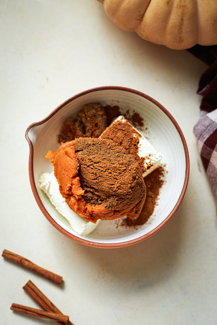 cream cheese with pumpkin puree, spices, and brown sugar in a bowl