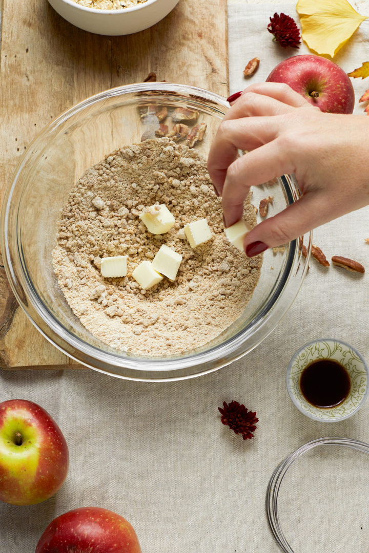 woman making crumble topping for bourbon apple crisp