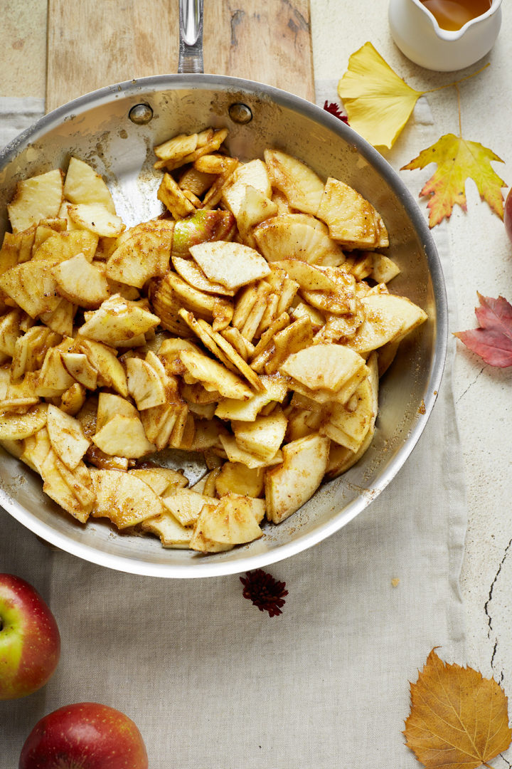 apples being sauteed with spices and sugar for apple crisp