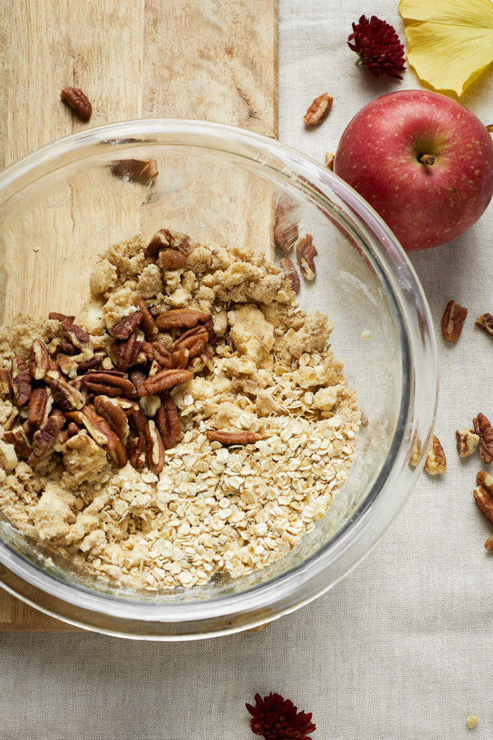 adding pecans and oats to crisp topping