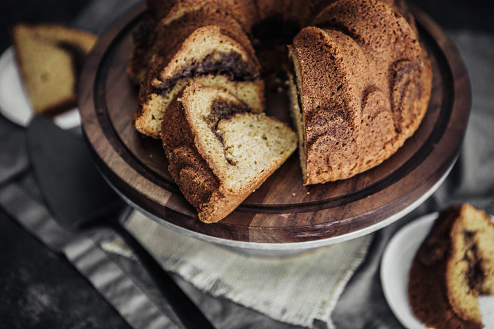 slices of cardamom coffee cake on a wooden cake stand