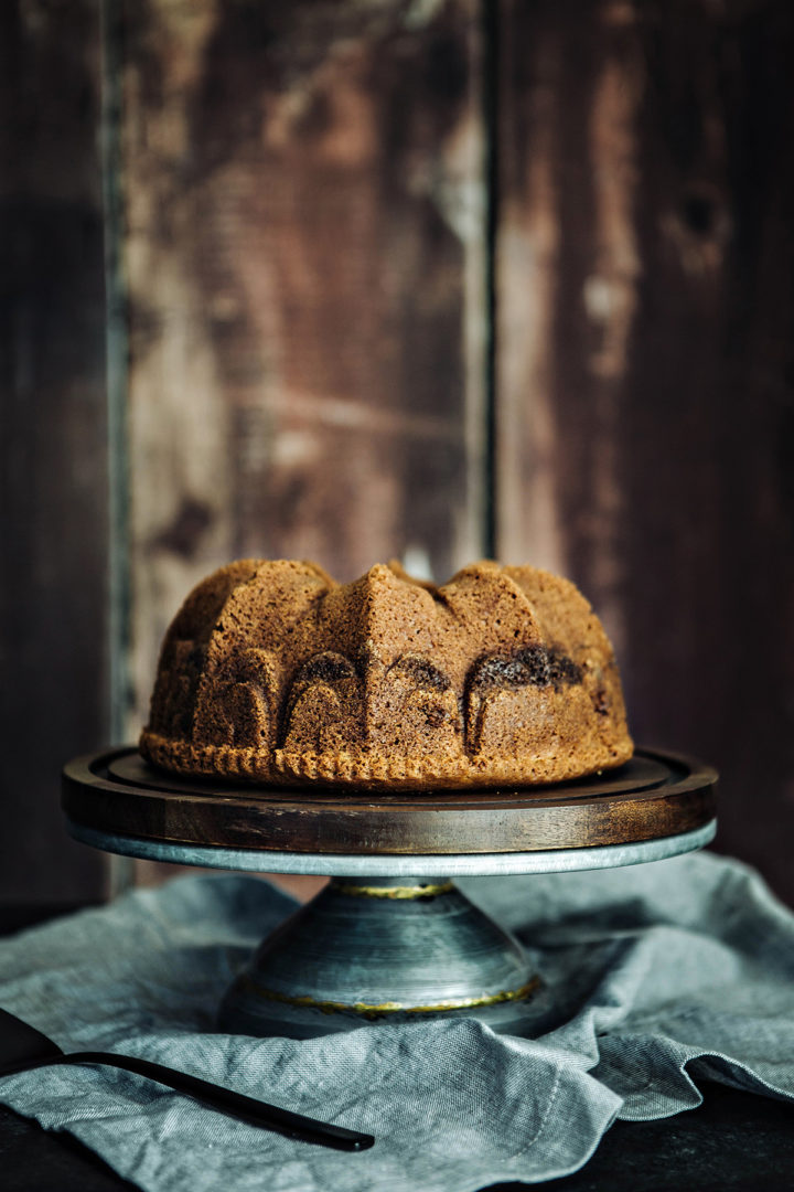 cardamom coffee cake on a wooden cake stand