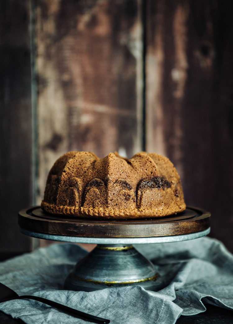 cardamom coffee cake on a wooden cake stand