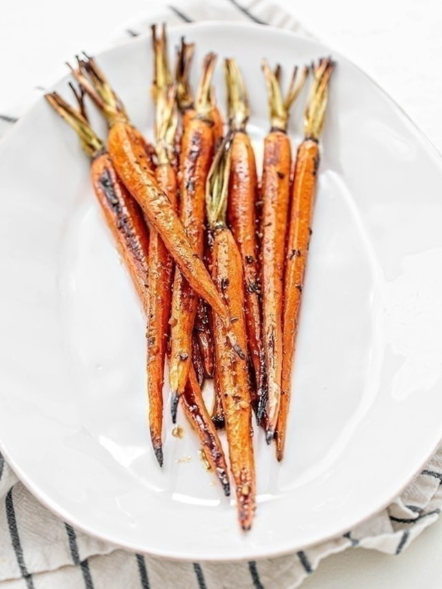 whole roasted carrots on white plate