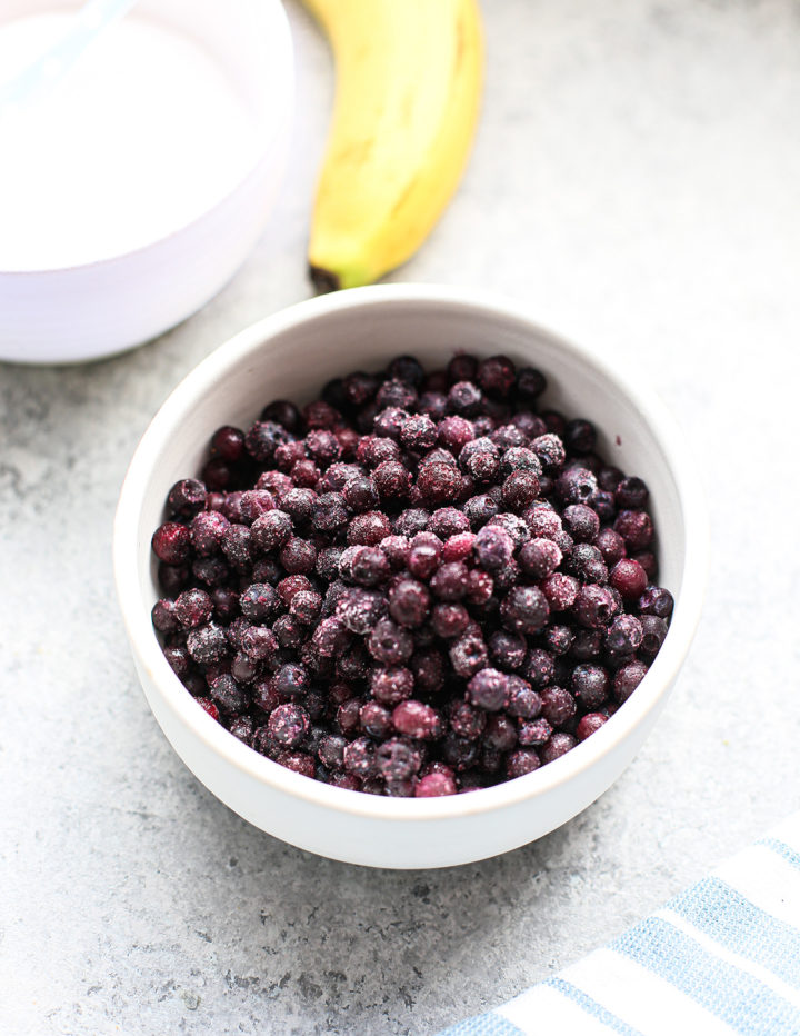 frozen blueberries thawing on a counter