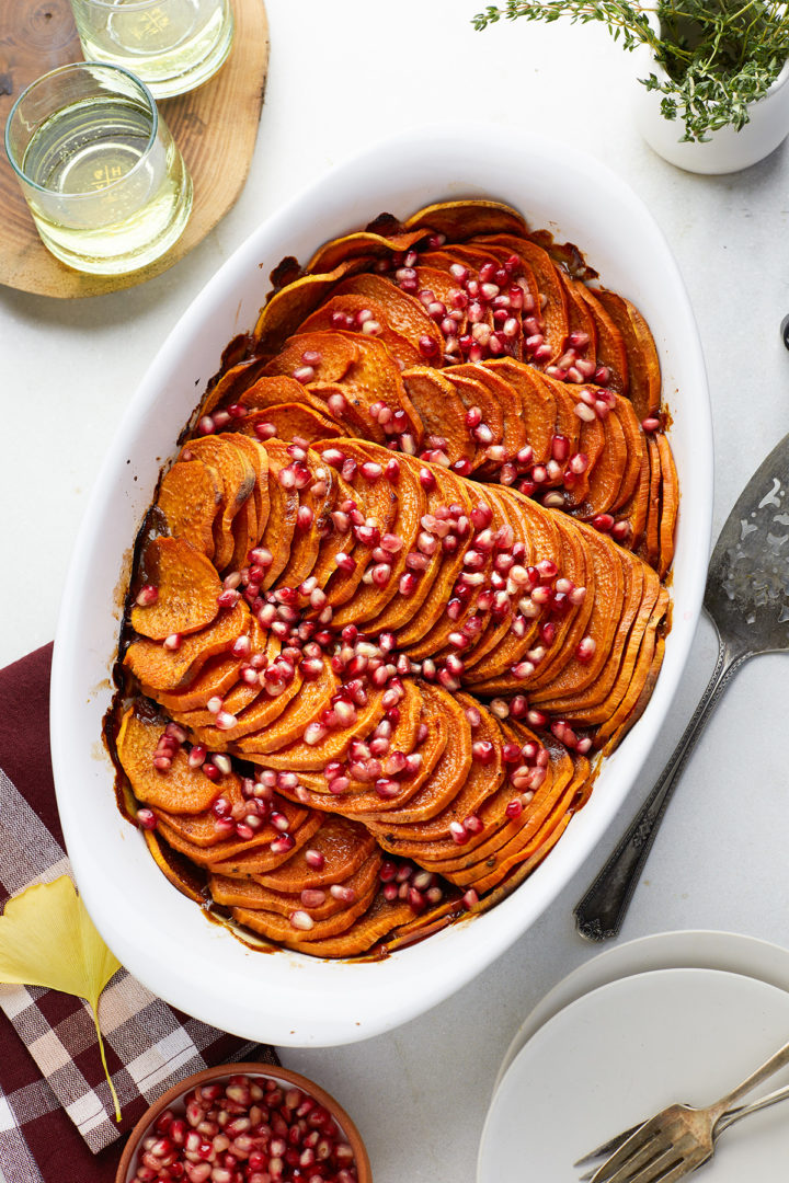 sliced sweet potato bake in a white casserole dish