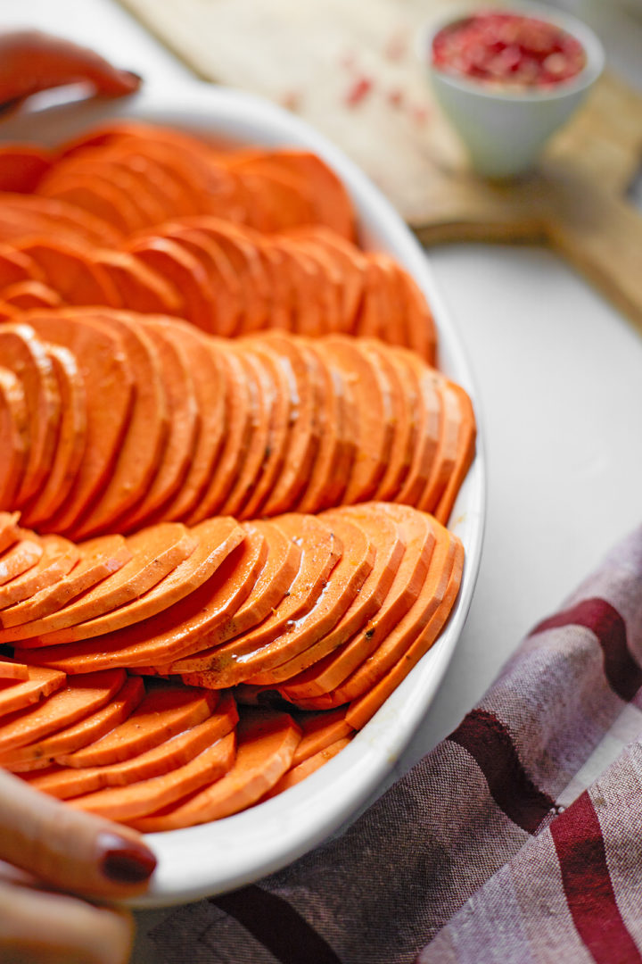 woman holding a sliced sweet potato casserole