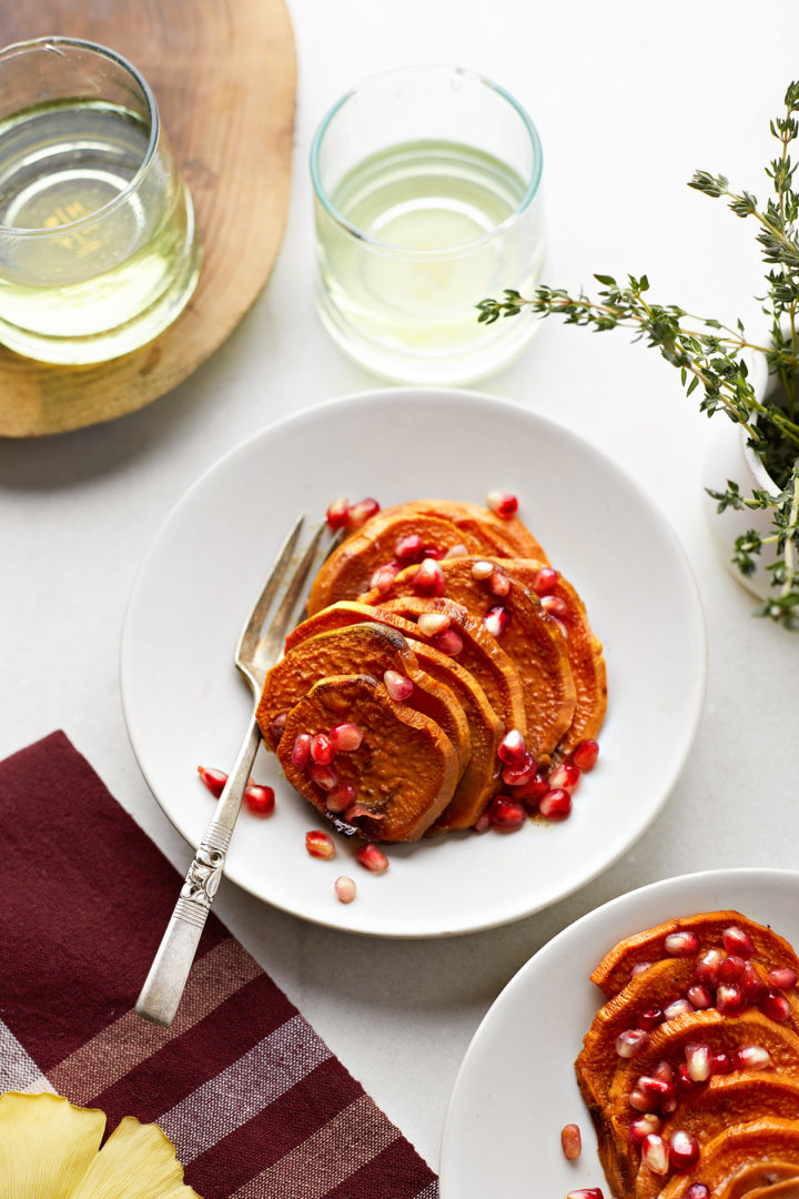 a plate of sliced sweet potato pomegranate casserole on a plate