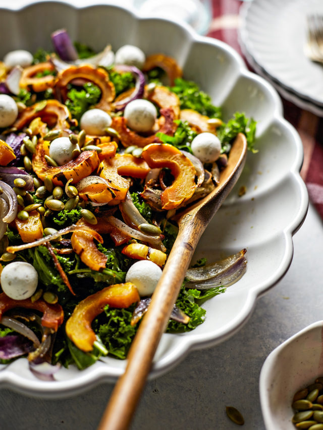 kale salad with roasted delicata squash in a bowl