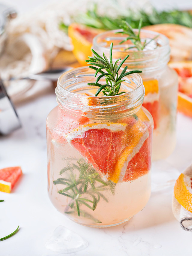 photo of a vodka tonic with grapefruit and rosemary served in mason jars