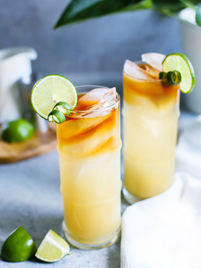 photo of 2 glasses of a mai tai garnished with limes