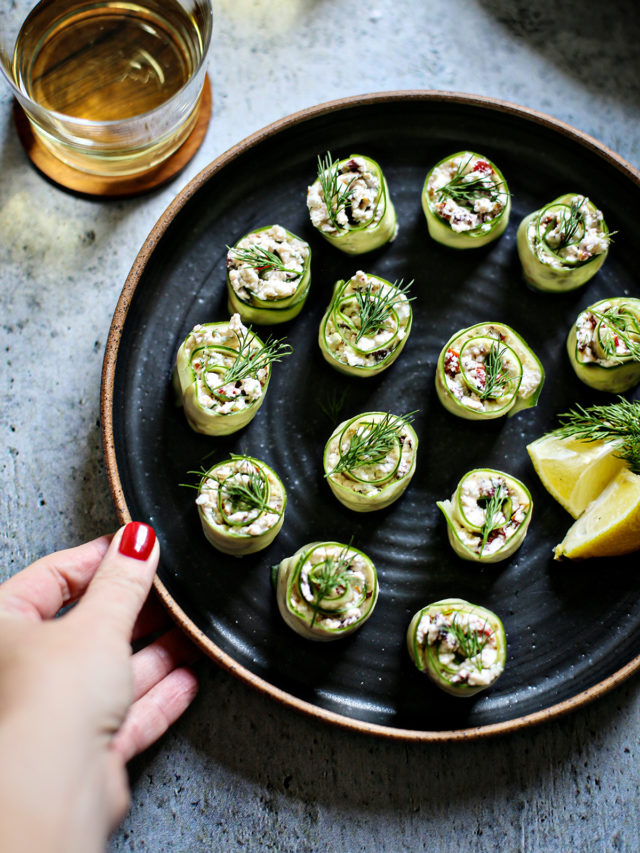 cucumber rolls ups on a black plate