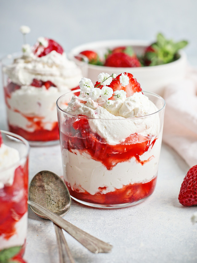 strawberries and cream served in three clear dessert dishes