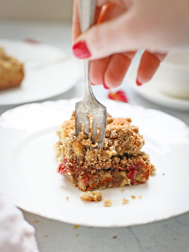 woman eating a slice of rhubarb coffee cake