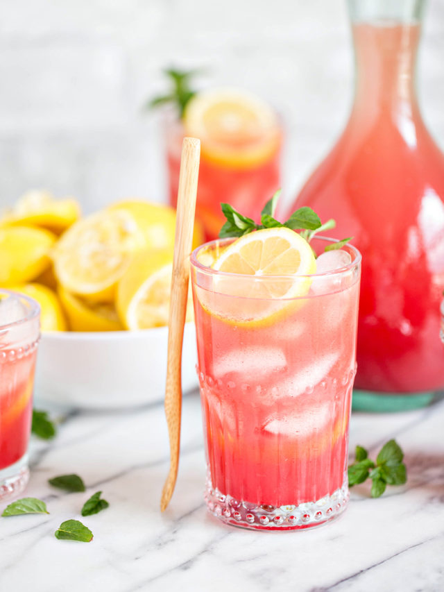 Homemade Watermelon Lemonade in glasses with lemon and mint garnish