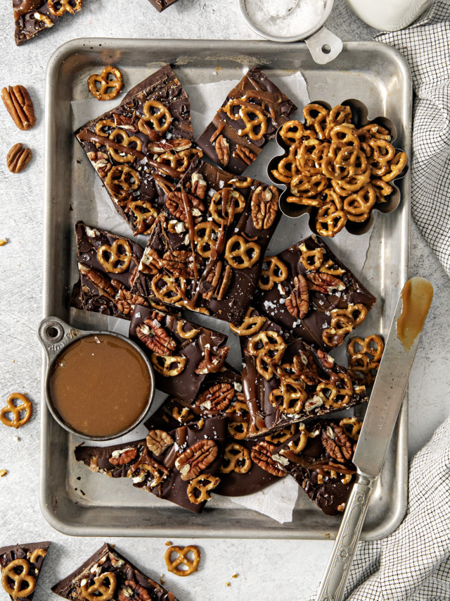 overhead photo of pretzel bark on a baking sheet next to a bowl of salted caramel