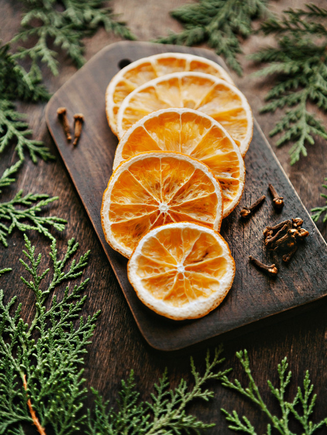 dried orange slices on a wooden cutting board