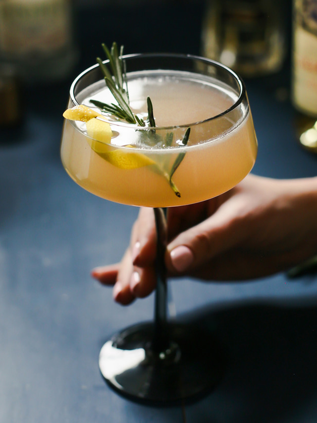 woman holding a glass of french blonde cocktail