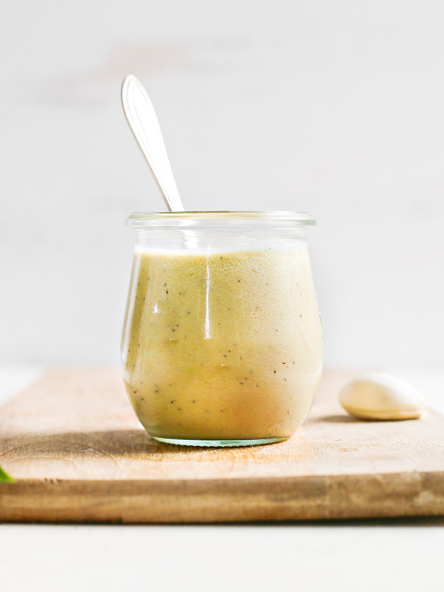 homemade caesar dressing in a jar with spoon