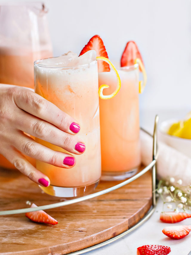 woman holding a glass of strawberry lemonade