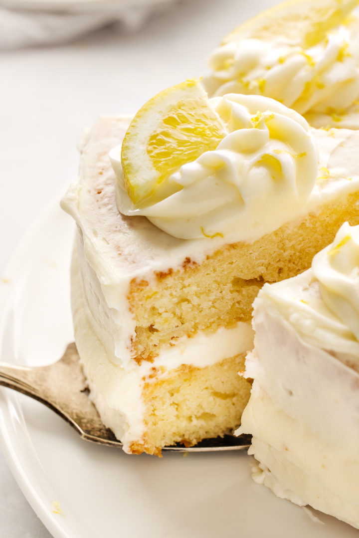 close up of a slice of lemon layer cake being served