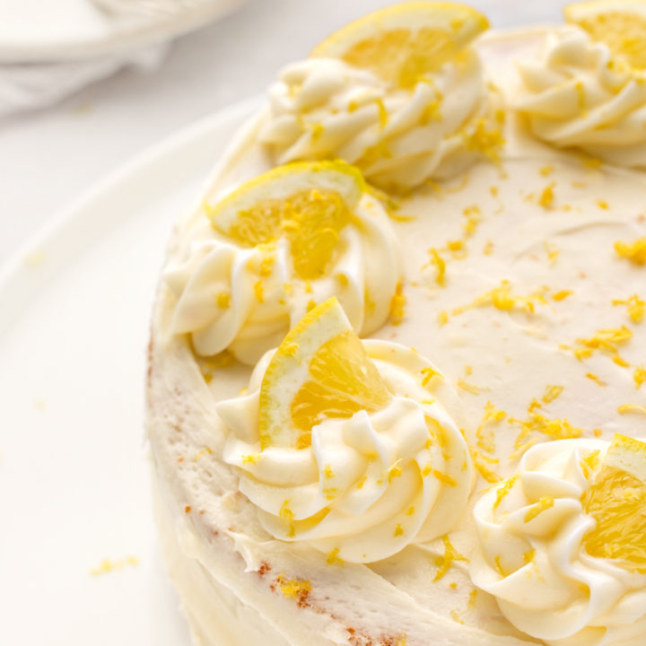 lemon layer cake decorated with lemon slices and lemon zest