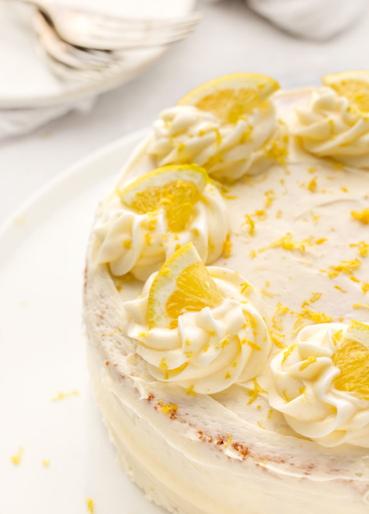 lemon layer cake decorated with lemon slices and lemon zest