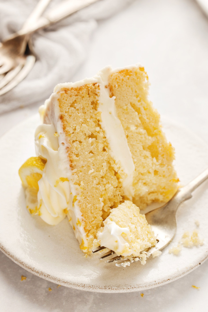 a fork cutting into a slice of a simple lemon cake