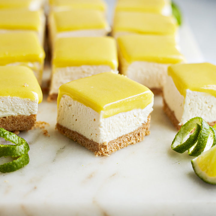 squares of lime cheesecake bars on a marble board