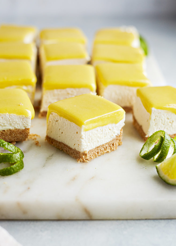 squares of lime cheesecake bars on a marble board