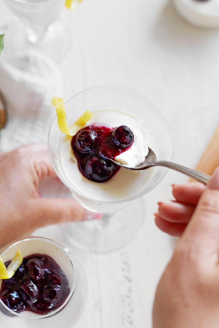 woman eating blueberry lemon panna cotta