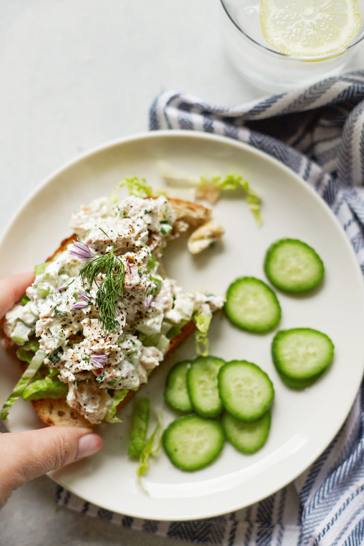 woman eating a sandwich made with yogurt chicken salad