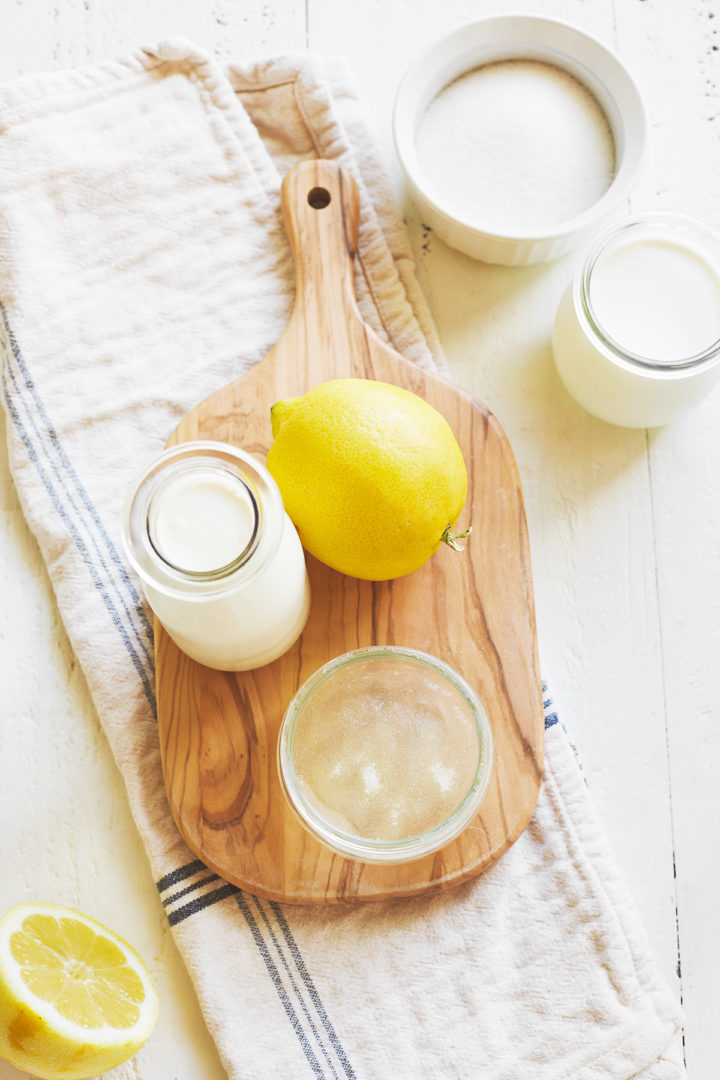 ingredients to make lemon panna cotta arranged on a cutting board