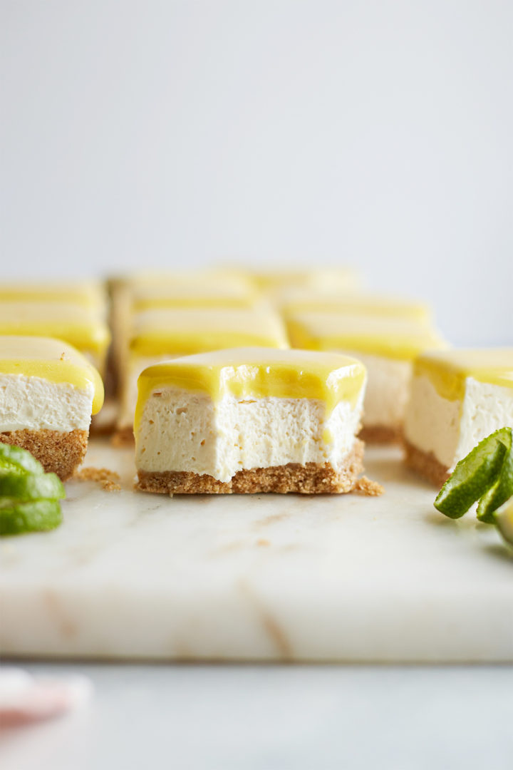 a bite taken out of a lime bar with cream cheese 