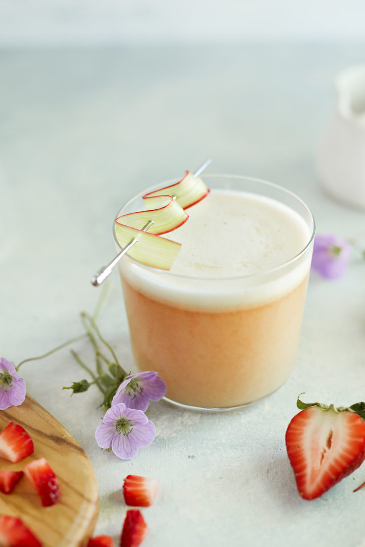 strawberry whiskey sour with egg white in a glass 