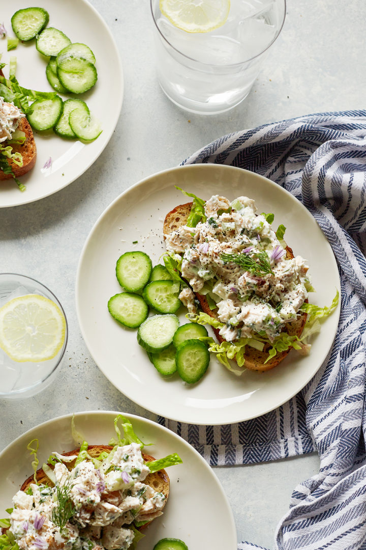 overhead photo of plates of open faced greek yogurt chicken salad sandwiches