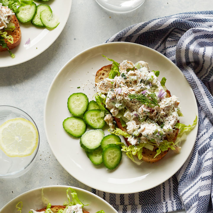 overhead photo of greek yogurt chicken salad with green apples on white plates