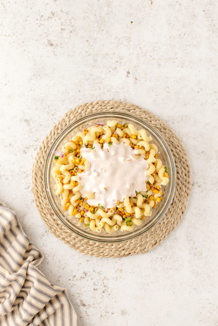 adding dressing to pasta salad ingredients