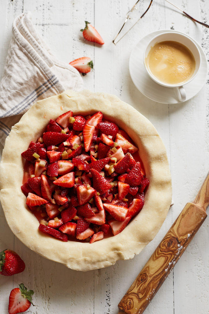 unbaked pie crust filled with strawberry rhubarb pie filling