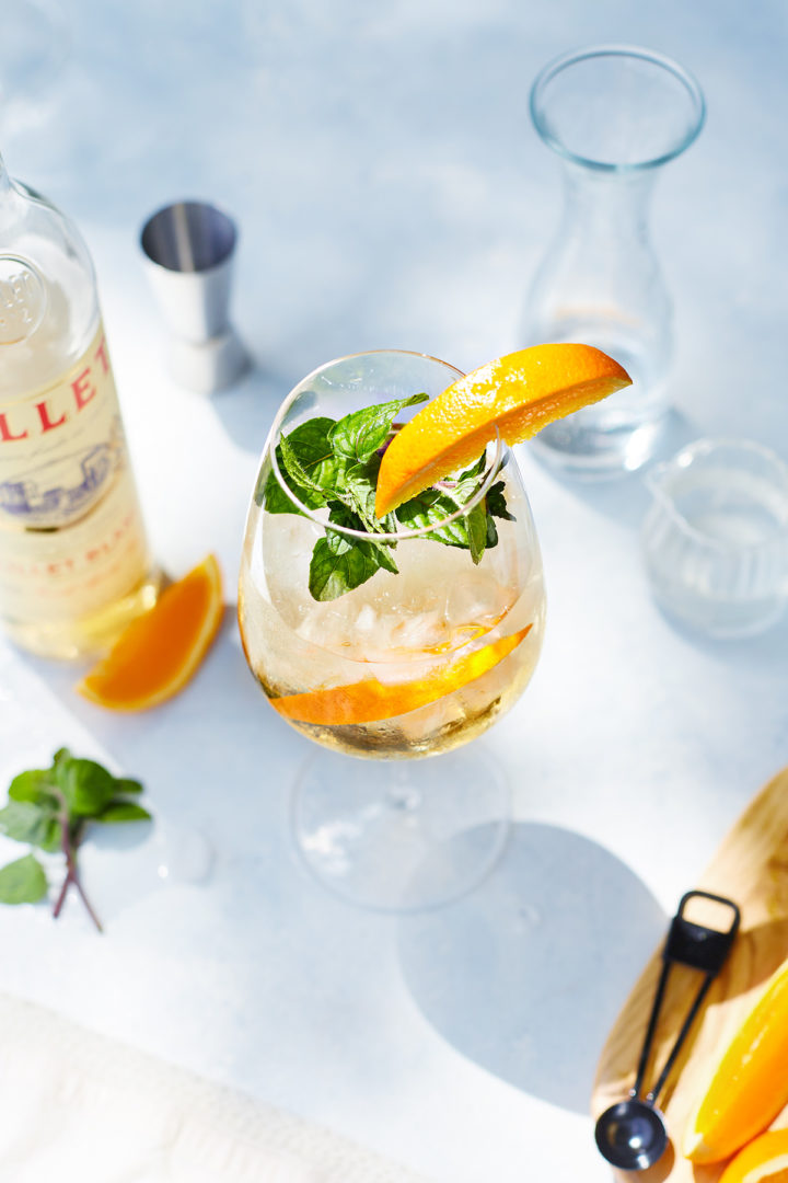 lillet blanc spritz garnished with orange and mint