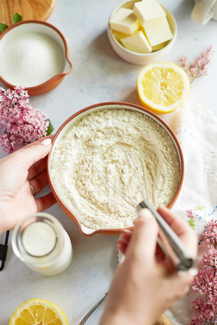 woman stirring flour to make lemon and poppyseed scones